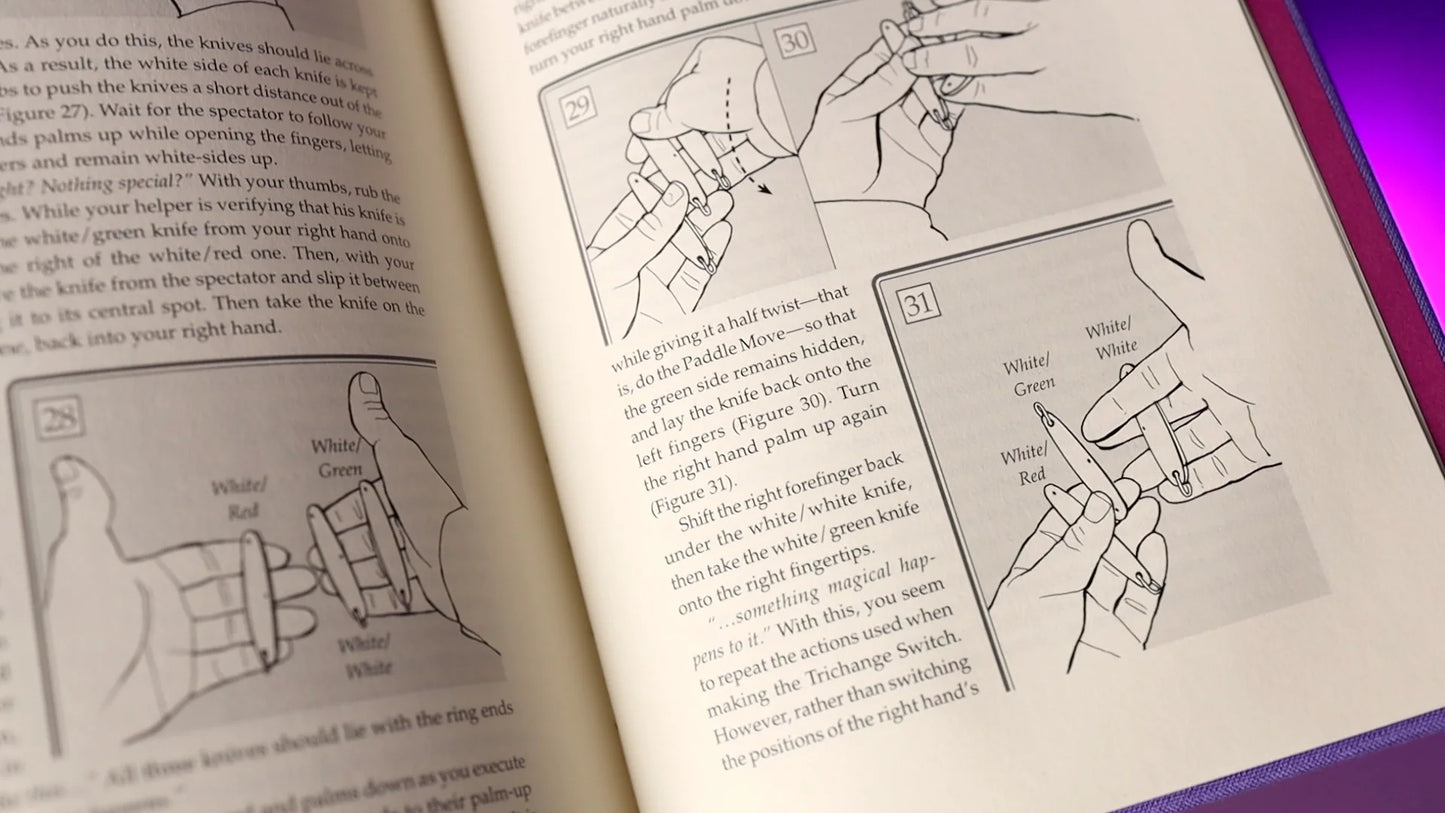 Open Flamenco magic book by Juan Tamariz showing knife manipulation instructions.