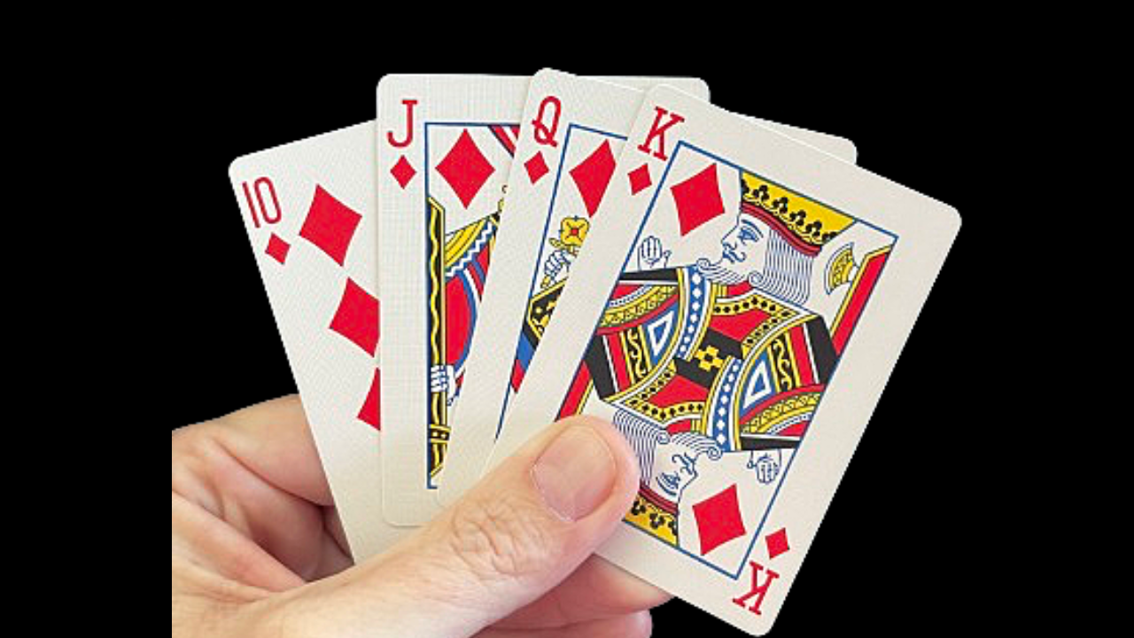 Hand holding four playing cards, showing a 10, Jack, Queen, and King of Diamonds.