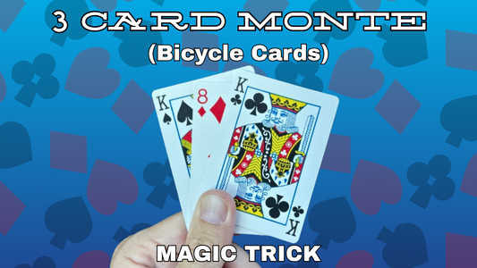 A hand holds three playing cards—King of Spades, 8 of Diamonds, and King of Clubs—against a blue background with card suit symbols. Text reads 3 Card Monte (Bicycle Cards) and Magic Trick from the best magic shop.