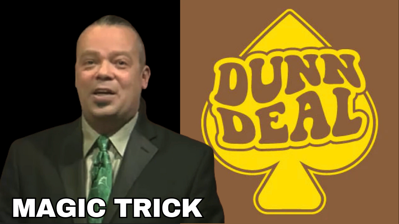 Man in suit performing a magic trick, with the Dunn Deal logo in the background.