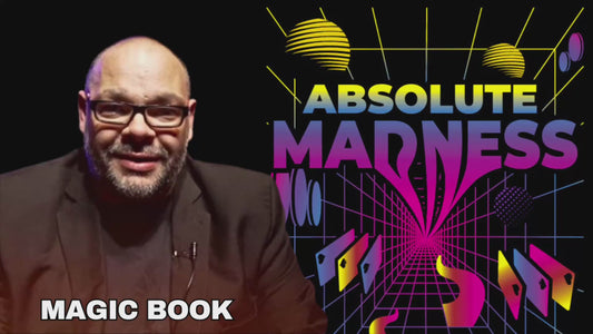 Man in suit discusses the "Absolute Madness" magic book.