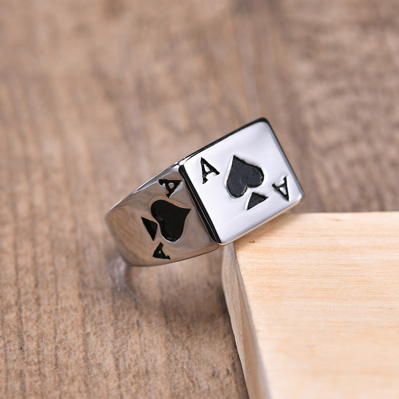 Silver ring with black ace of spades design.