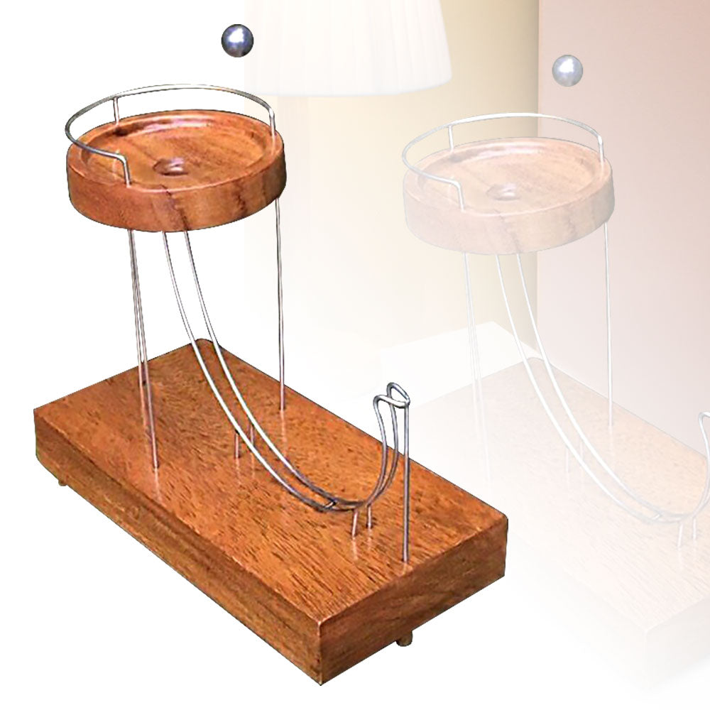 Wooden ball-launching toy with two metal ramps and a circular wooden platform.
