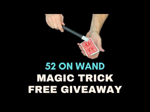 Hands holding a playing card with a magic wand positioned above, for a 52 on wand magic trick free giveaway.