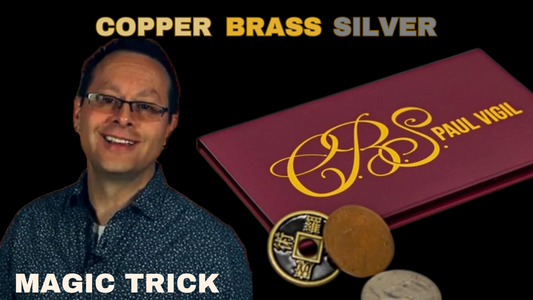 Man performing a magic trick with copper, brass, and silver coins in a maroon case.