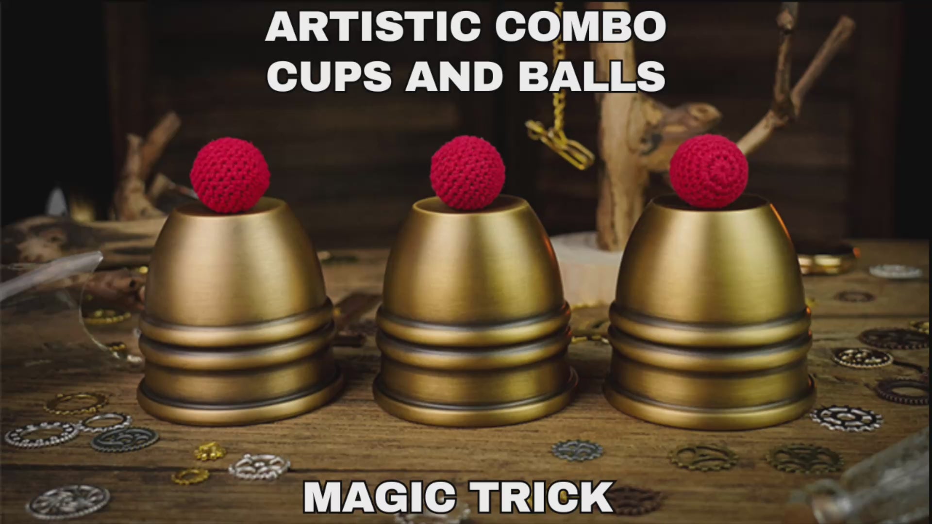 Three brass cups with three crochet red balls displayed ready to perform a magic cups and balls routine