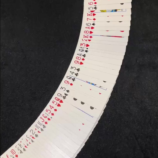 Magic tutorial video showing the Biddle card trick with a deck of cards arranged and several cards face up. Video