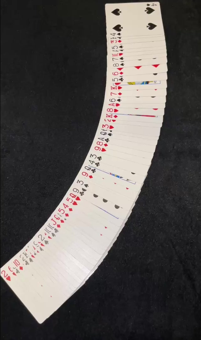 Magic tutorial video showing the Biddle card trick with a deck of cards arranged and several cards face up. Video