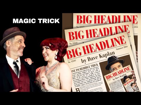 Two people in 1920s attire, smiling, stand in front of multiple newspapers featuring a large headline and a description of a magic trick.

