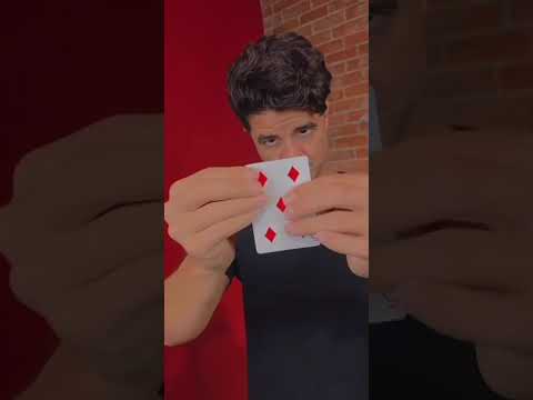 Person performing a "Diamond Cutter" magic trick, holding a playing card. Short video